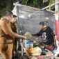 Foto: Bupati Kupang, Yosef Lede,SH., berkesempatan menikmati jagung bakar di stan UMKM, lapangan Voli Camplong